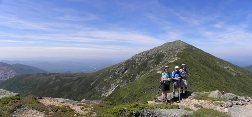 Hikers on Franconia Ridge with Mount Lafayette looming in the background in NH on June 2010