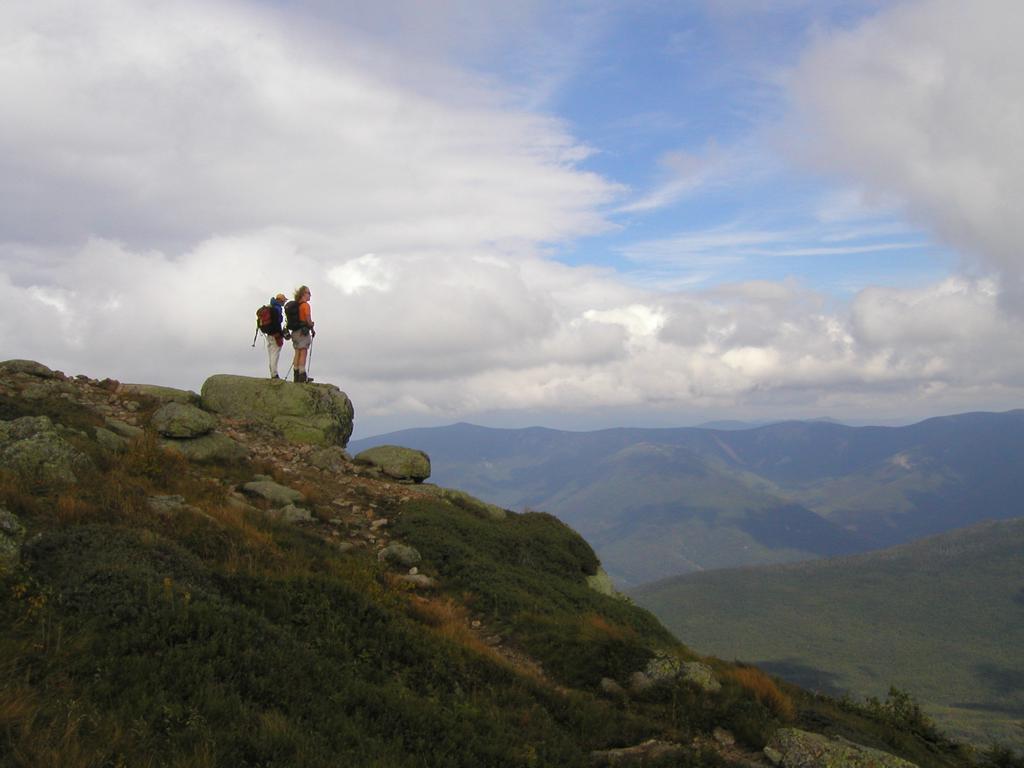 a pair of hikers takes in the stormy view in September on Franconia Ridge in the White Mountains of New Hampshire