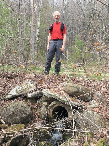 Fred stands above the under-road water culvert on the Green Trail at Lamson Farm in southern New Hampshire
