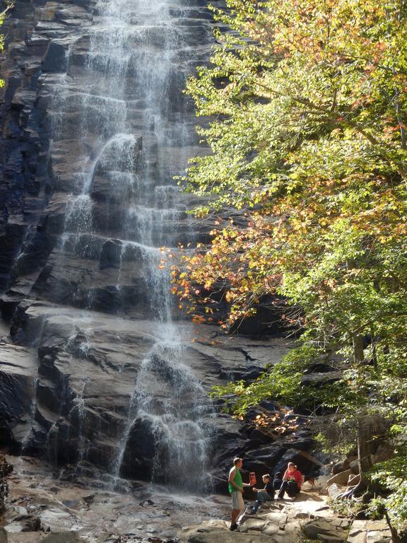 colorful hikers and late-summer foliage at Arethusa Falls near Crawford Notch in New Hampshire