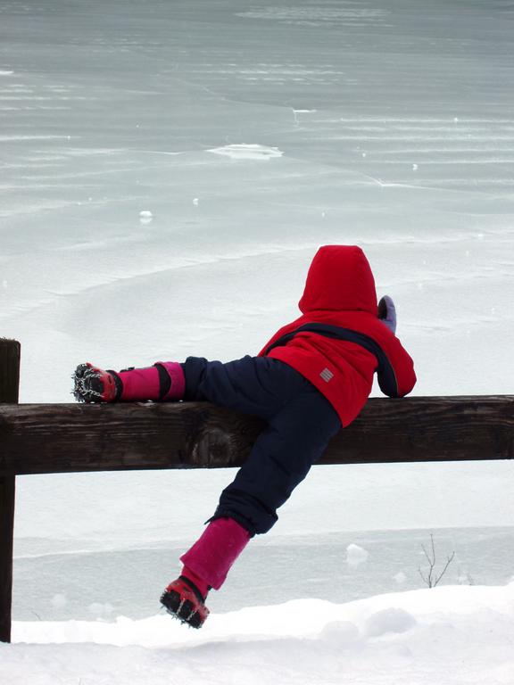 young winter hiker by Mountain Pond at Pawtuckaway State Park in New Hampshire