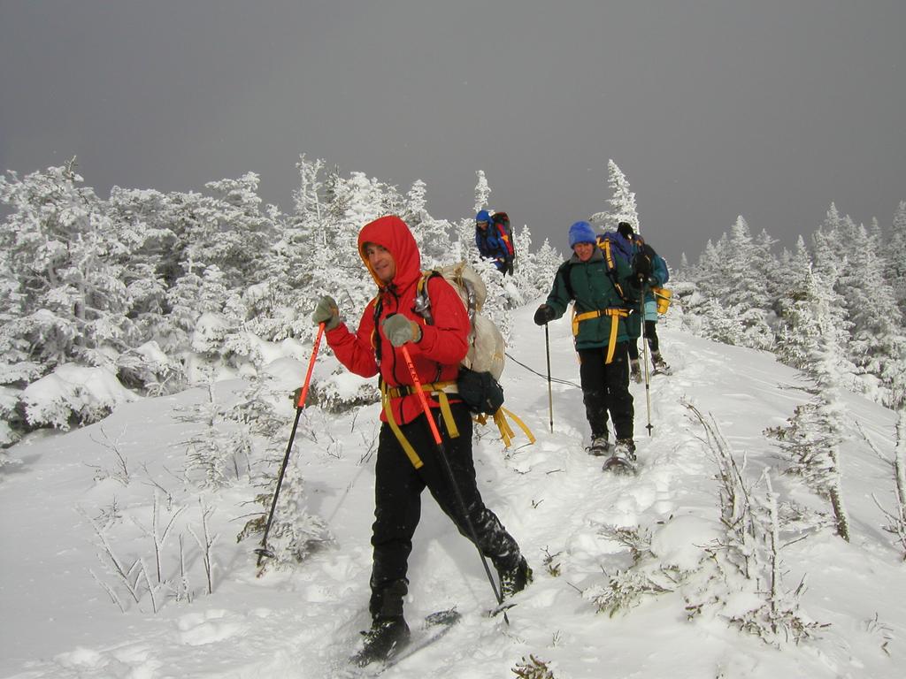 hikers snowshoeing down from the summit of Mount Moriah in New Hampshire