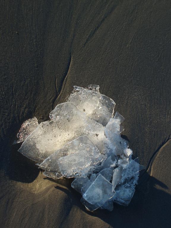 ice shards on the sand at York Beach in Maine