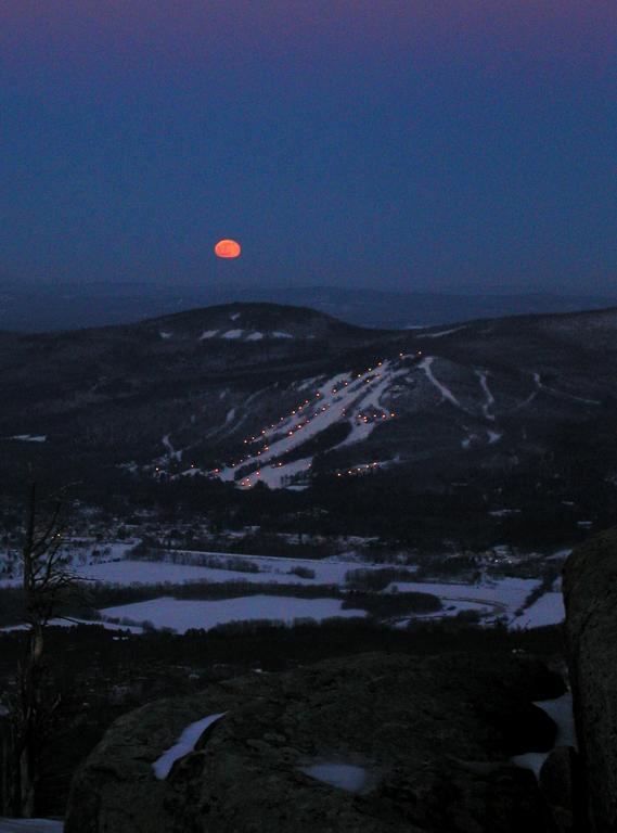 winter moonrise over Cranmore Ski Area as seen from South Moat Mountain in New Hampshire