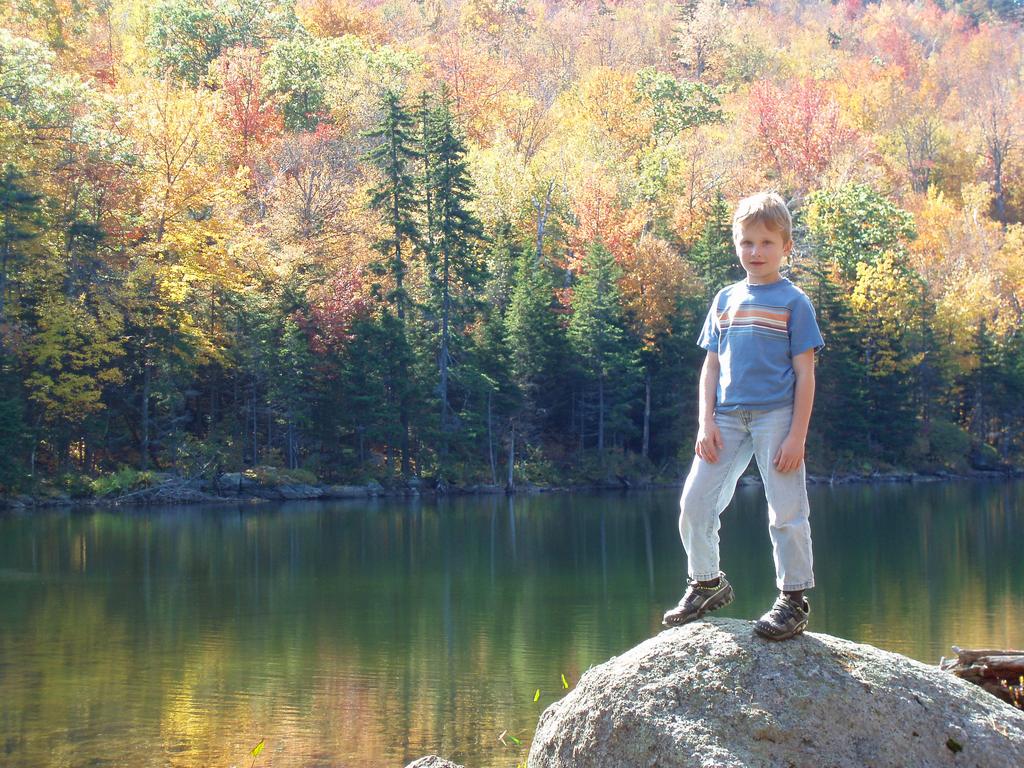 young hiker at Jack's Pond on the way to Thumb Mountain in New Hampshire