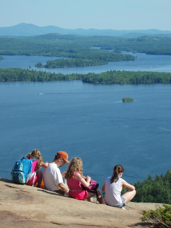 hikers and view from West Rattlesnake Mountain in New Hampshire