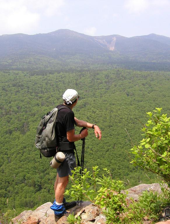 hiker and view from near the summit of Owl's Head Mountain in New Hampshire