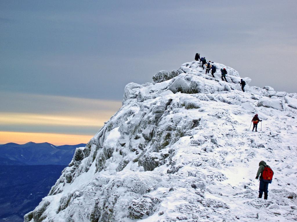 winter hikers summit Mount Monroe in New Hampshire