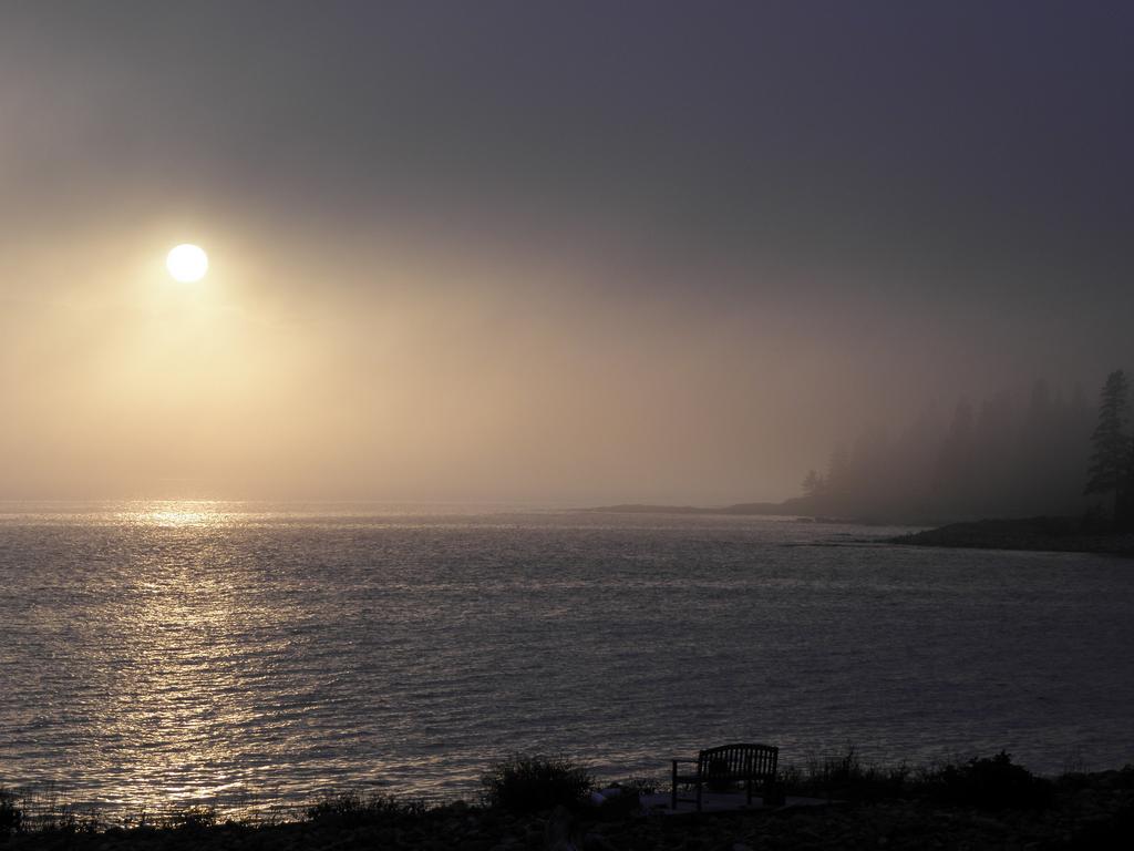 sun glow through fog across Frenchman Bay near Pemetic Mountain in Maine