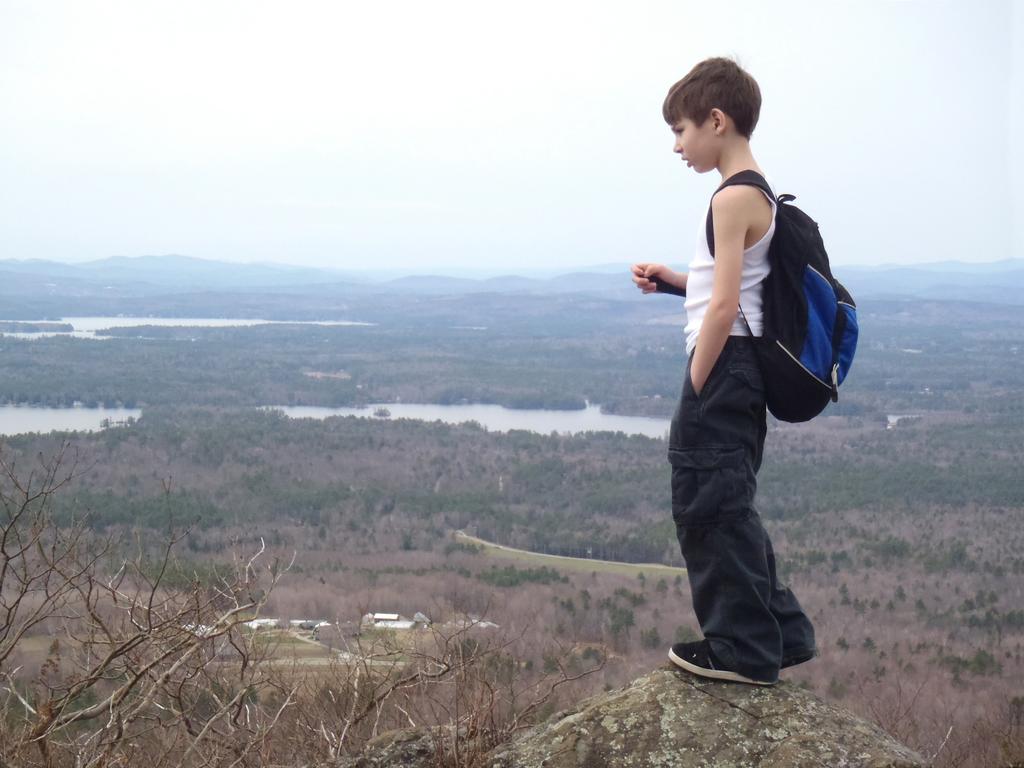 young hiker at the mid-trail viewpoint on Mount Roberts in New Hampshire