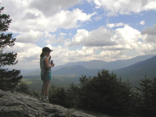 hiker and view from Lookout Ledge in New Hampshire