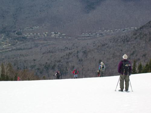 hikers head down the ski slopes in April at Loon Mountain in New Hampshire