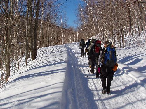 winter hikers on Sawyer River Road on the way to Mount Lowell in New Hampshire