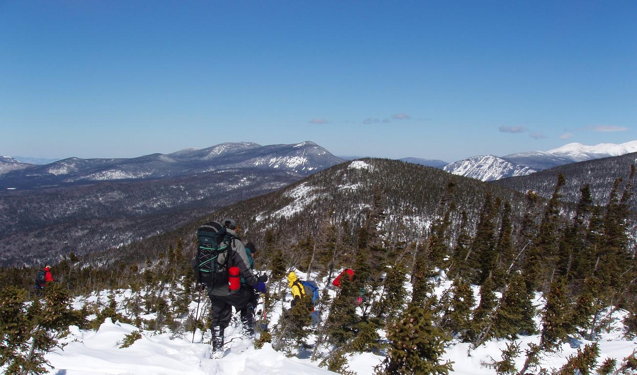 March bushwhackers on Mount Lowell enjoy a fine view of the White Mountains in New Hampshire
