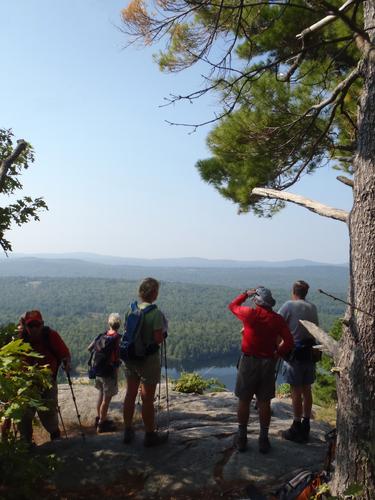 hikers at an outlook on the trail to Mount Anna in New Hampshire