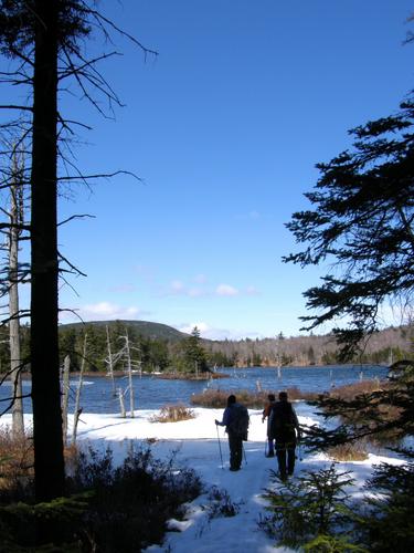 spring hikers at Round Pond on the way to Mount Mack in New Hampshire