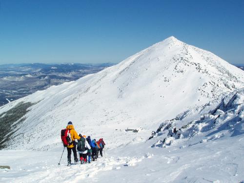 winter hikers head down from the shoulder of Mount Adams toward Mount Madison in the White Mountains of New Hampshire