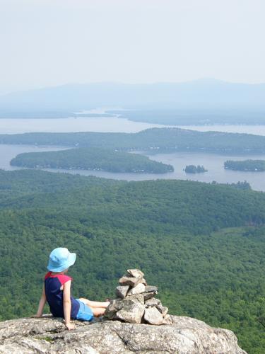 young hiker on the summit of Mount Major in New Hampshire