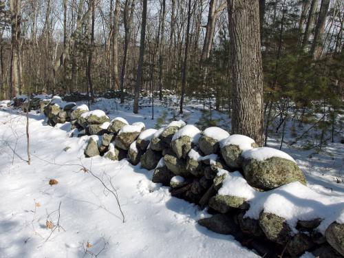 stone wall in February at the summit of Marble Hill near Stow in northeastern Massachusetts