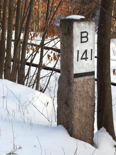 mile marker in January at Mascoma River Greenway at Lebanon in western New Hampshire