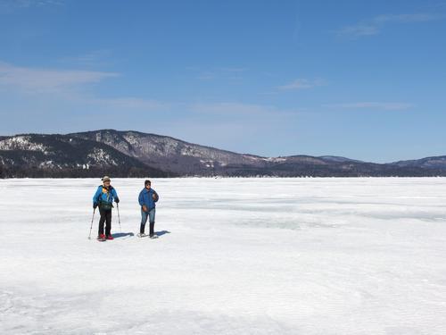 Dick and Elaine stand out in March on Newfound Lake in New Hampshire on our walk-on-water way to Mayhew Island