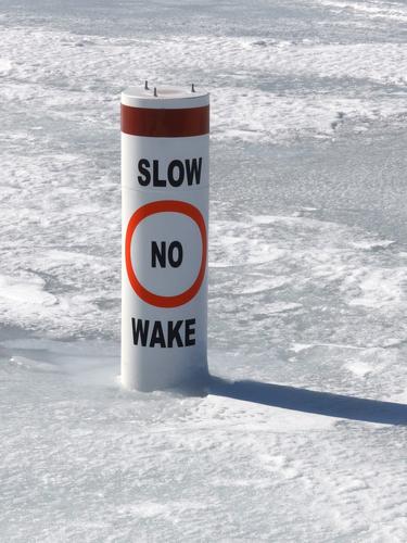 unnecessary speed warning sign in winter on Newfound Lake near Mayhew Island in New Hampshire