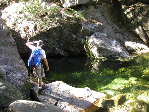 hiker at Emerald Pool near Mount Meader in New Hampshire