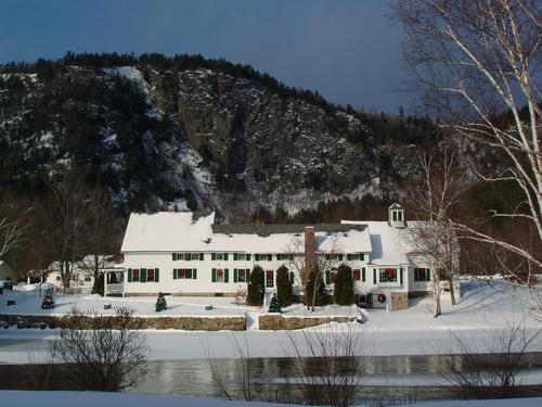 Stark Village Inn sports Christmas decor across the Ammonoosuc River in northern New Hampshire