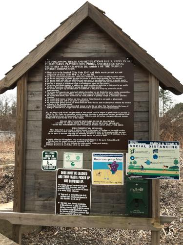 entrance kiosk with park rules in April at Mine Falls Park in New Hampshire