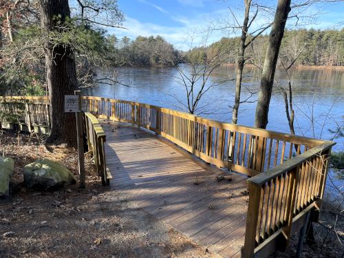 new boardwalk in December circling a projecting edge  of Mill Pond at Mine Falls Park in Nashua NH