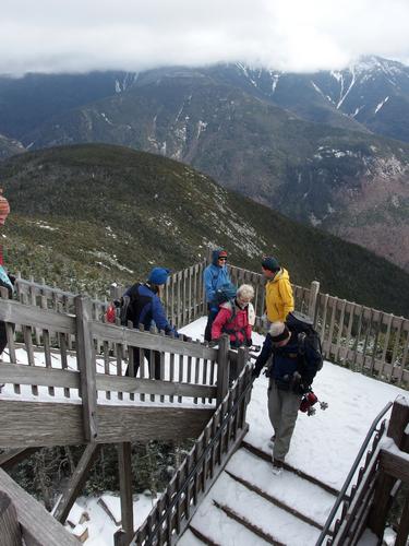hikers descending the summit platform stairs on Cannon Mountain in New Hampshire