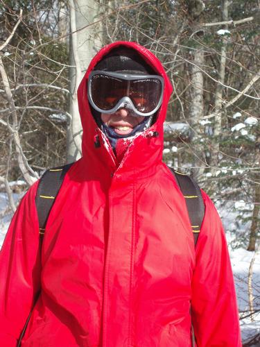 winter hiker bundled up to hike Mount Moosilauke in New Hampshire