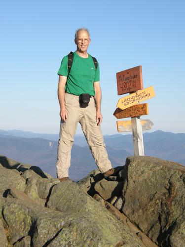 hiker on the summit of Mount Moosilauke in New Hampshire