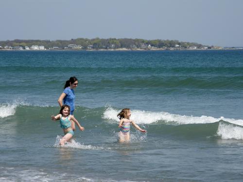 visitors enjoying the surf at Nahant Beach in Massachusetts