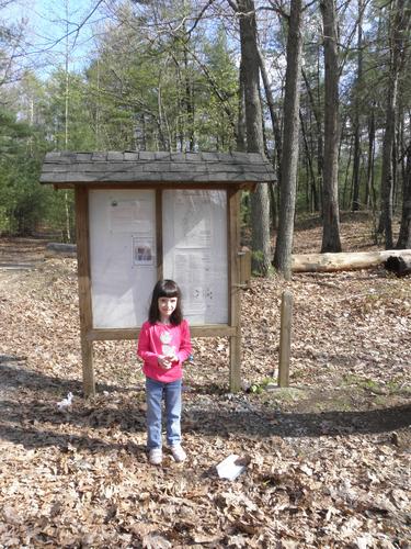 young hiker at the kiosk for Nashoba Brook Watershed in New Hampshire