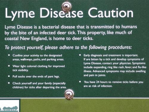 Lyme Disease Caution sign posted by the Trustees of Reservations at Noanet Woodlands in eastern Massachusetts