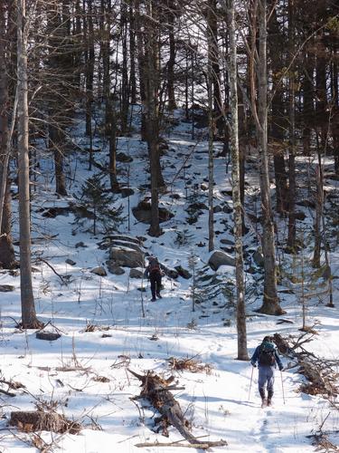 winter hikers on the way to Oak Hill in New Hampshire