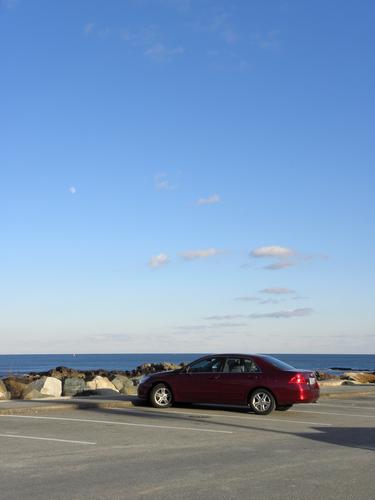 lonely car in the Perkins Cove parking lot in Maine