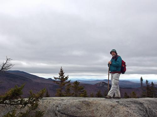 John stands atop Mount Oscar in New Hampshire with a westerly view toward Middle Sugarloaf Mountain, The Nubble, and many more mountains