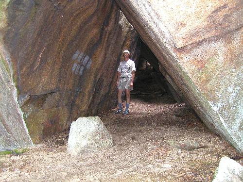 hiker in Big Rock Cave near Mount Mexico in New Hampshire