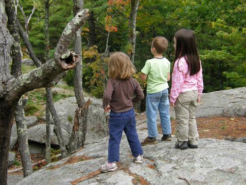 three young hikers on Pawtuckaway South Mountain in New Hampshire