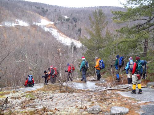 hikers headed down trail from Peaked Mountain in New Hampshire