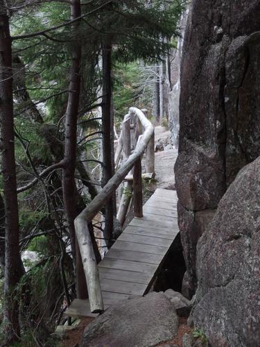 the trail navigates between cliff face and precipice on the way to Penobscot Mountain in Acadia Park, ME