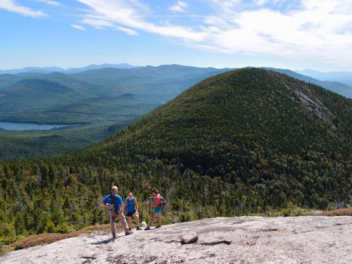 hikers on North Percy Peak with a view of South Percy Peak in New Hampshire