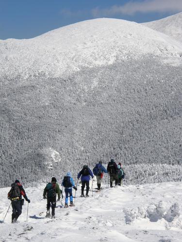 hikers on a snowy trail from Mount Pierce to Mount Eisenhower in New Hampshire