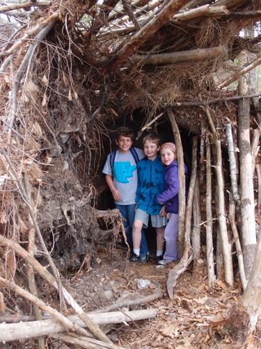 Garrett, Carl and Talia inside the root fort on Hooksett Pinnacle in southern New Hampshire