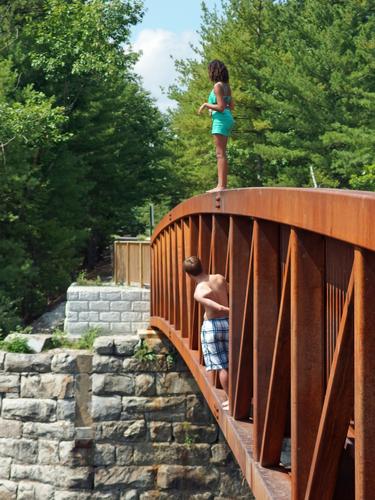 kids on the bridge over the Piscataquog River on the Piscataquog Trail in southern New Hampshire