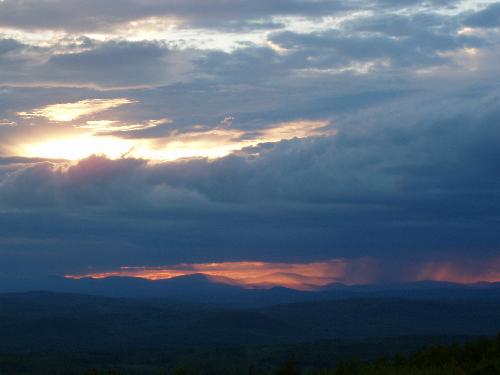 dissipating storm clouds at sunset as seen from the fire tower on Pitcher Mountain in southern New Hampshire