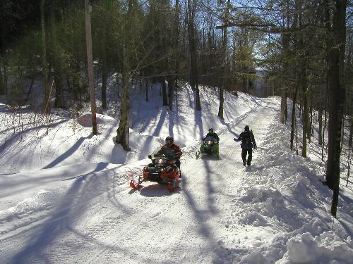 snowmobilers and hiker on Plymouth Mountain in New Hampshire