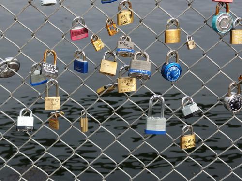a padlock collection on the waterfront chainlink fence beside Prescott Park at Portsmouth in New Hampshire